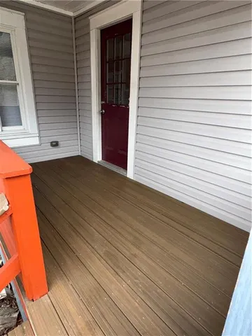 a view of a big house with table and chairs under an umbrella