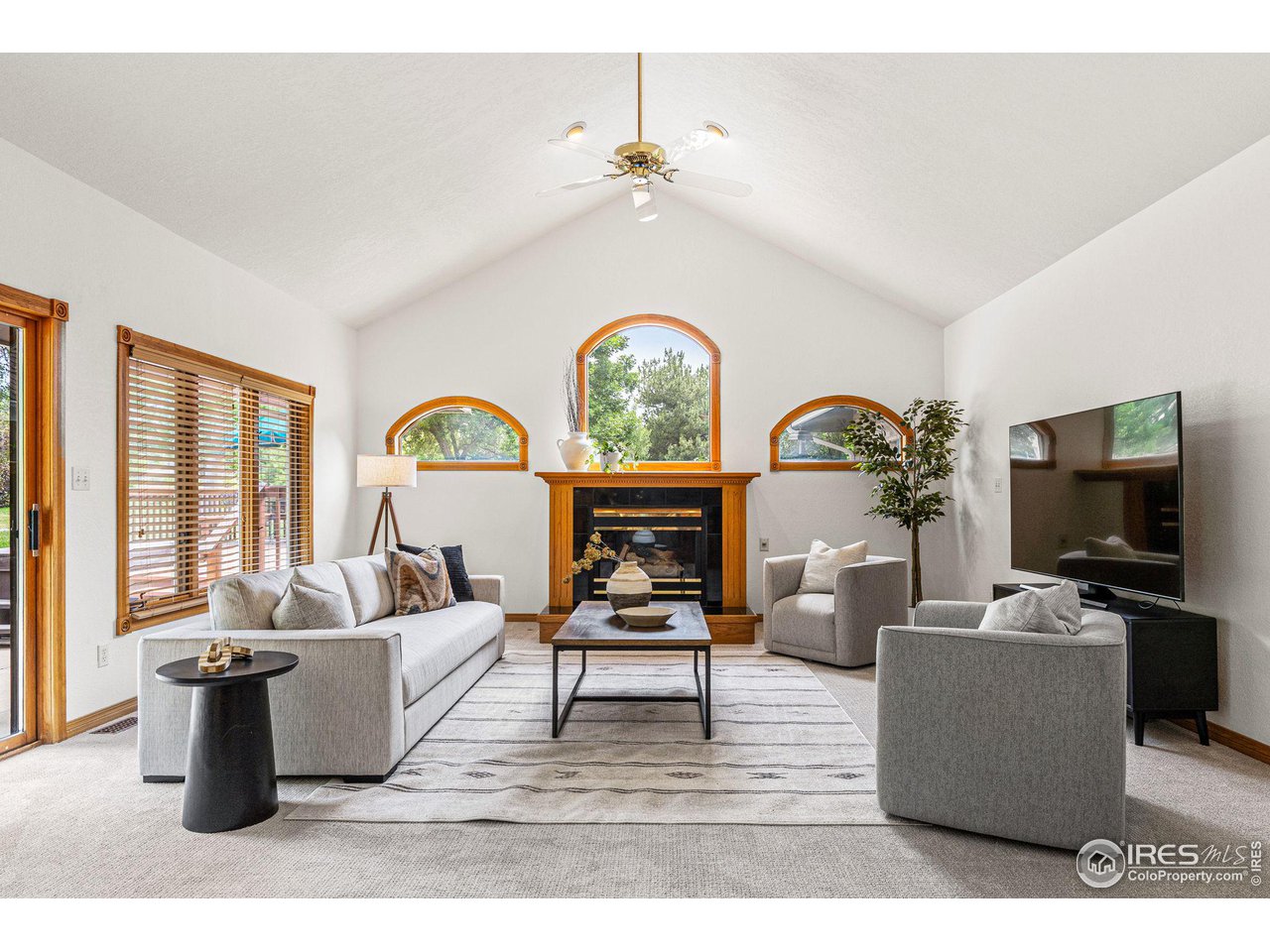 6968 Springhill Drive Niwot, CO 80503 - Photo 12 of 40 a living room with furniture a chandelier and a flat screen tv