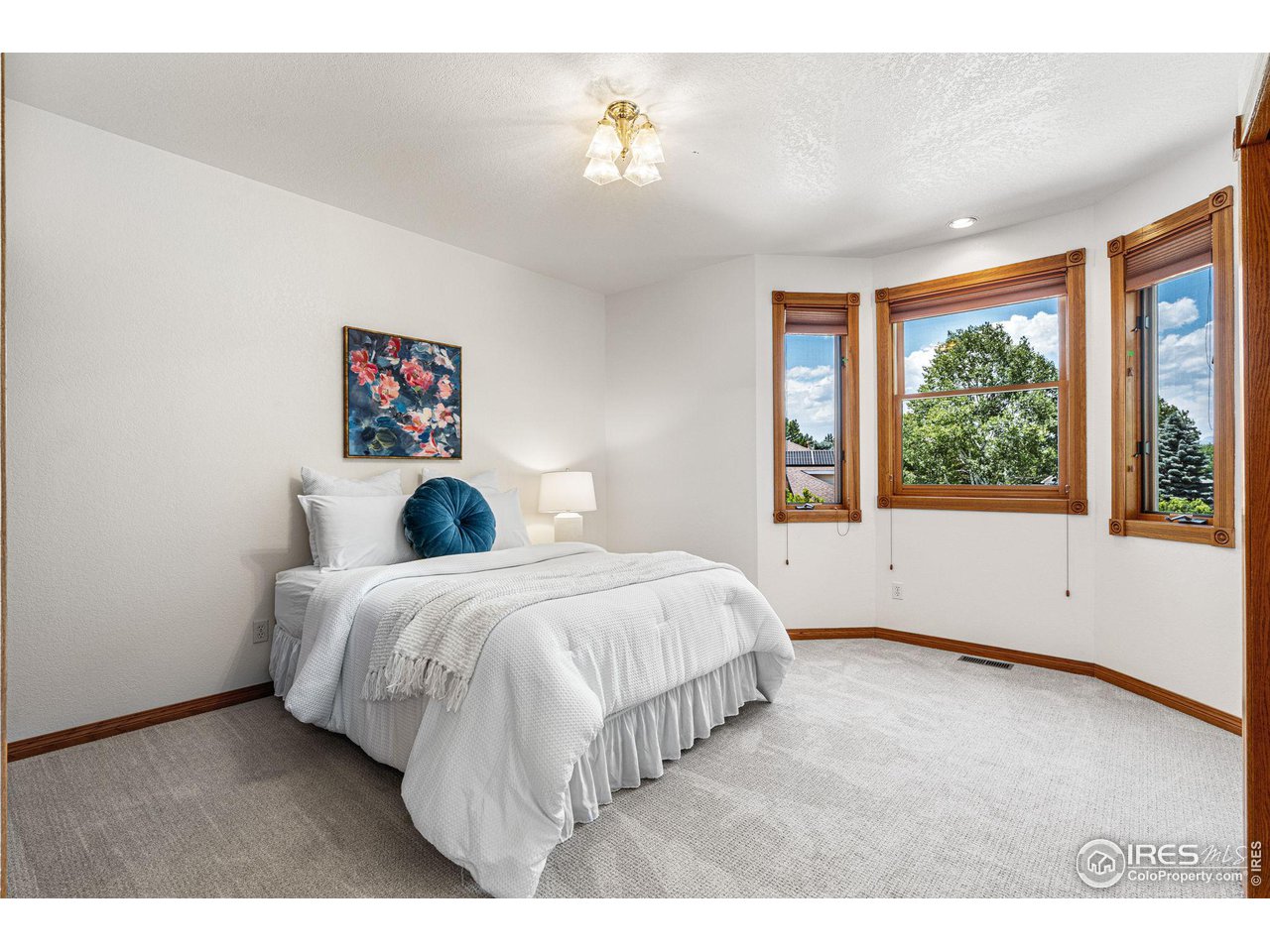 6968 Springhill Drive Niwot, CO 80503 - Photo 22 of 40 a bedroom with a bed and a large window
