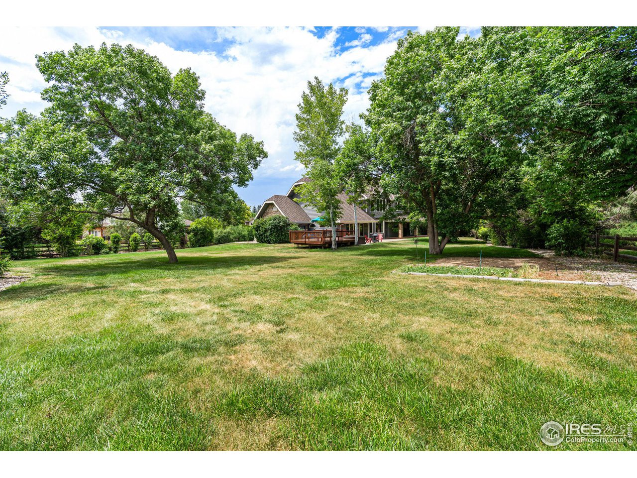 6968 Springhill Drive Niwot, CO 80503 - Photo 32 of 40 a view of outdoor space with deck and yard