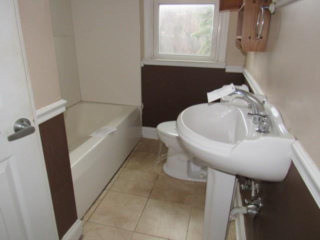 563 Agnew Road Greensburg, PA 15601 - Photo 9 of 16 a white bath tub sitting next to a white sink and a toilet