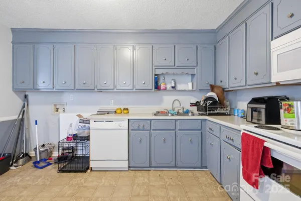 a kitchen with cabinets and white appliances