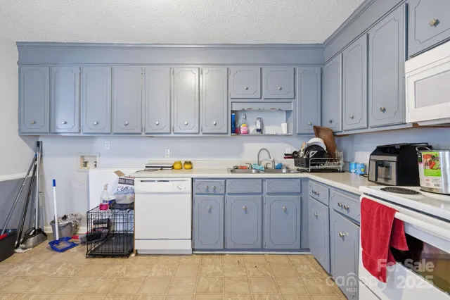 a kitchen with cabinets and white appliances