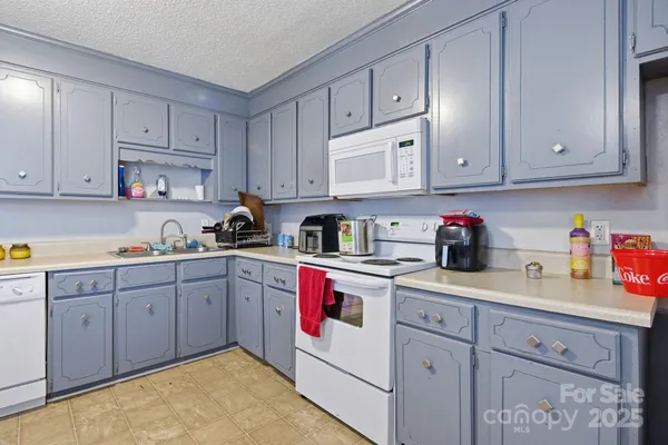 a living room with furniture a piano and a flat screen tv