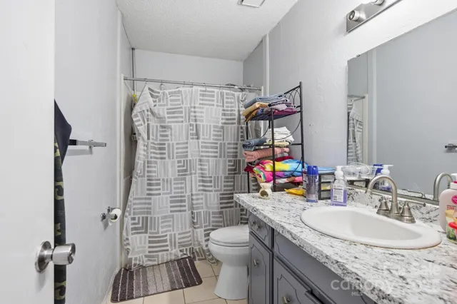 a bedroom with a bed and flat screen tv