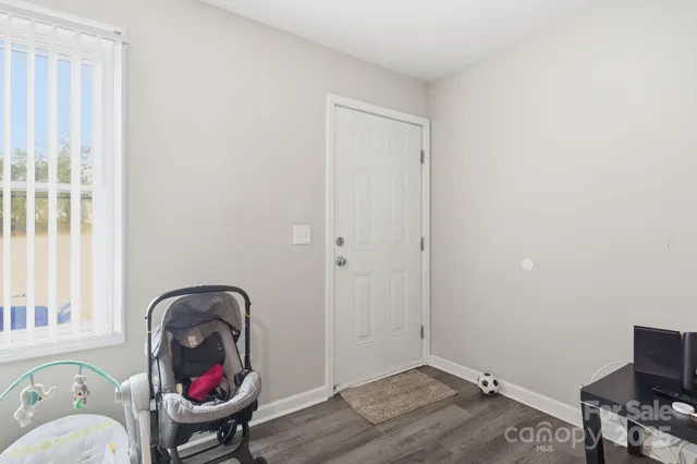 a bedroom with furniture and a wooden floor