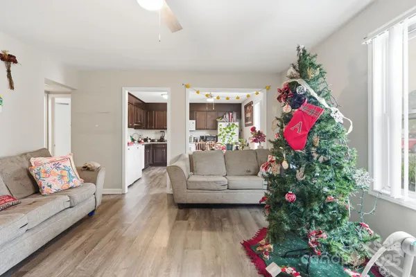 a kitchen with granite countertop stainless steel appliances a dining table and chairs