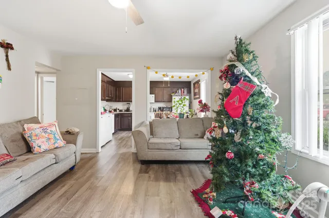 a kitchen with granite countertop stainless steel appliances a dining table and chairs
