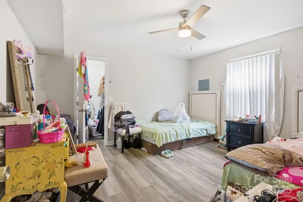 a bedroom with two bed and window