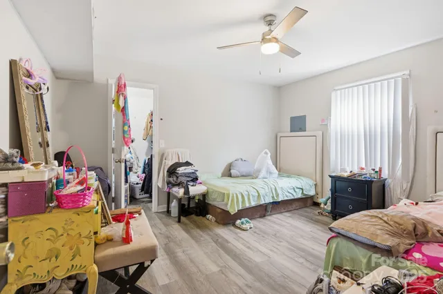 a bedroom with two bed and window