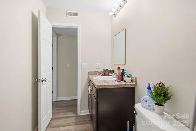 a bedroom with a bed a books bucket with a desk and chair