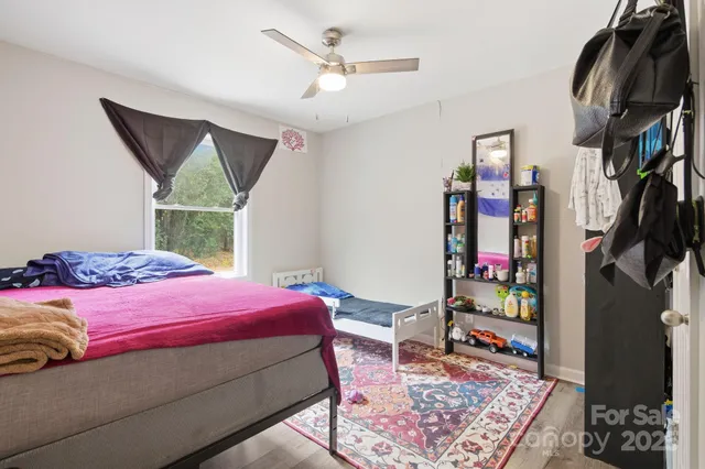 a bedroom with a bed and a painting on the wall