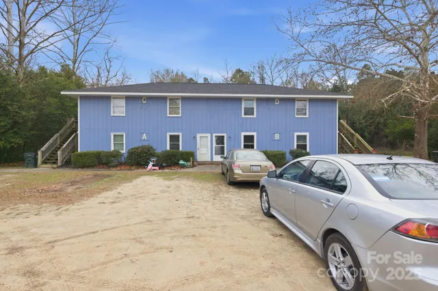 a view of a car park in front of a house