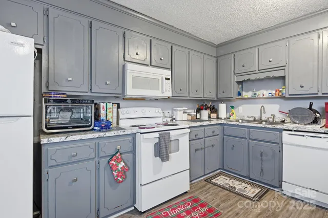 a utility room with sink dryer and washer