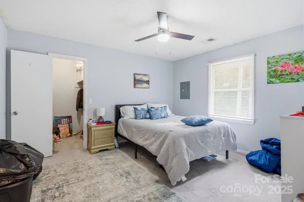 a bedroom with a bed and a painting on the wall
