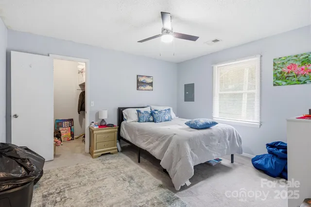a bedroom with a bed and a painting on the wall