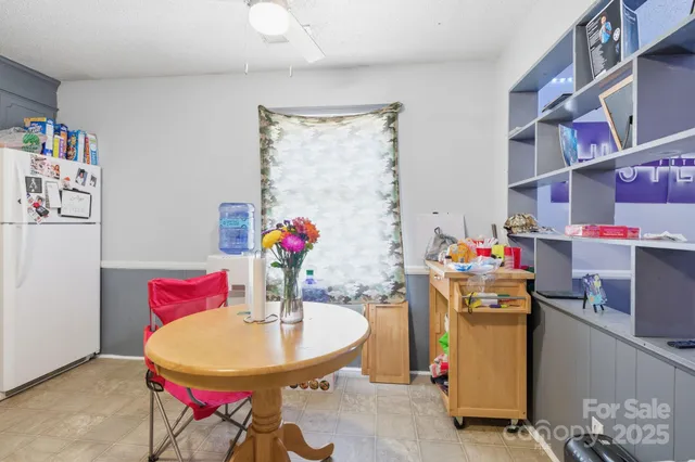 a kitchen with refrigerator and cabinets