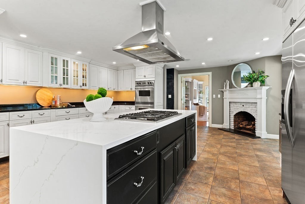 10 Stop River Road Norfolk, MA 02056 - Photo 6 of 29 a living room with a kitchen island furniture and a fireplace