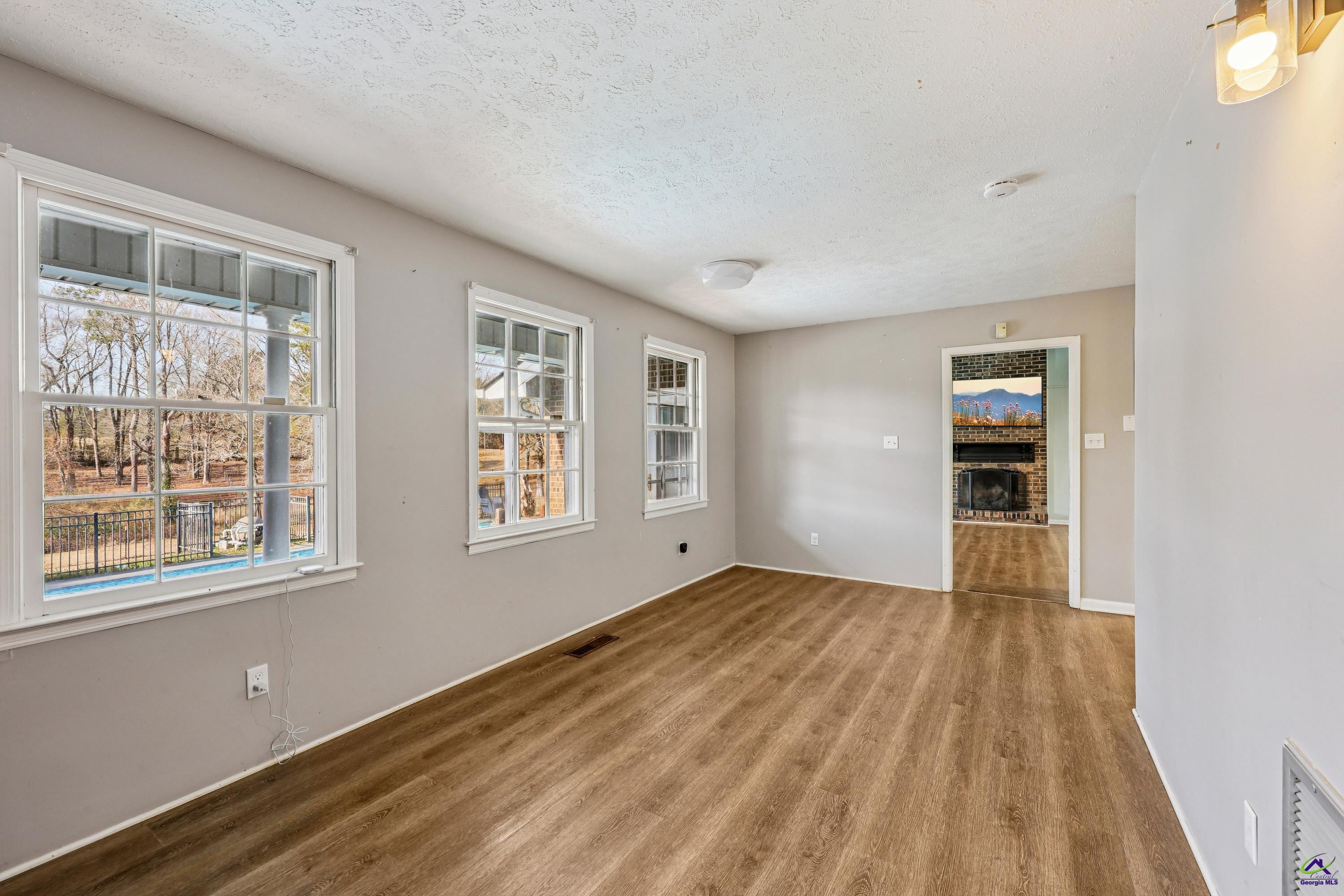 548 Greene Settlement Road Gray, GA 31032 - Photo 12 of 68 a view of an empty room with wooden floor and a window