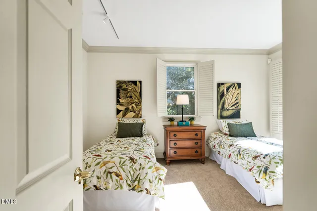 a bedroom with bed and wooden floor