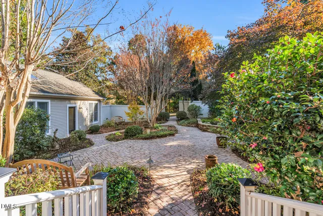 a view of a house with backyard sitting area and garden