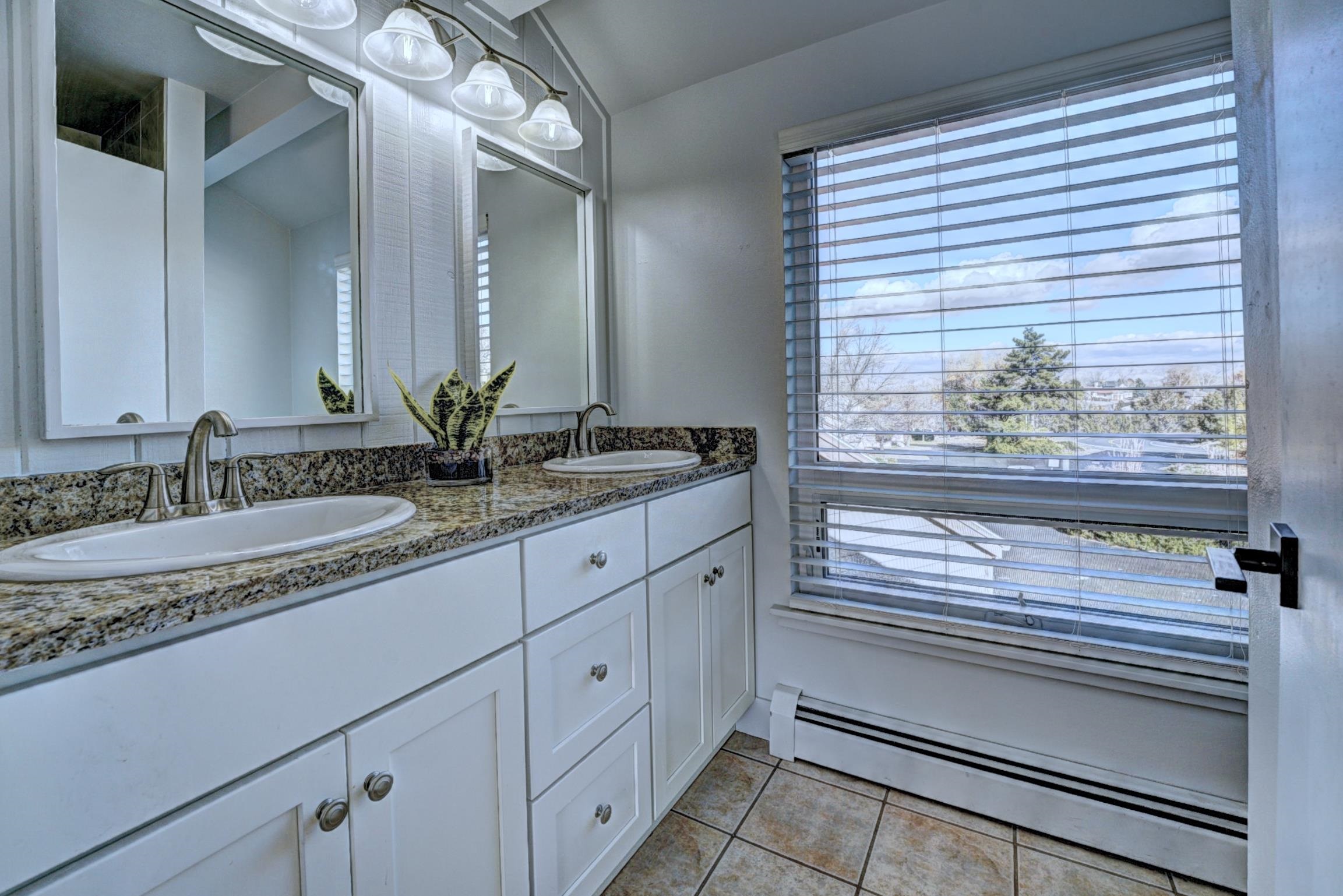 397 Ridge Cir Drive, Unit 8 Grand Junction, CO 81507 - Photo 18 of 40 a bathroom with a granite countertop sink and a window