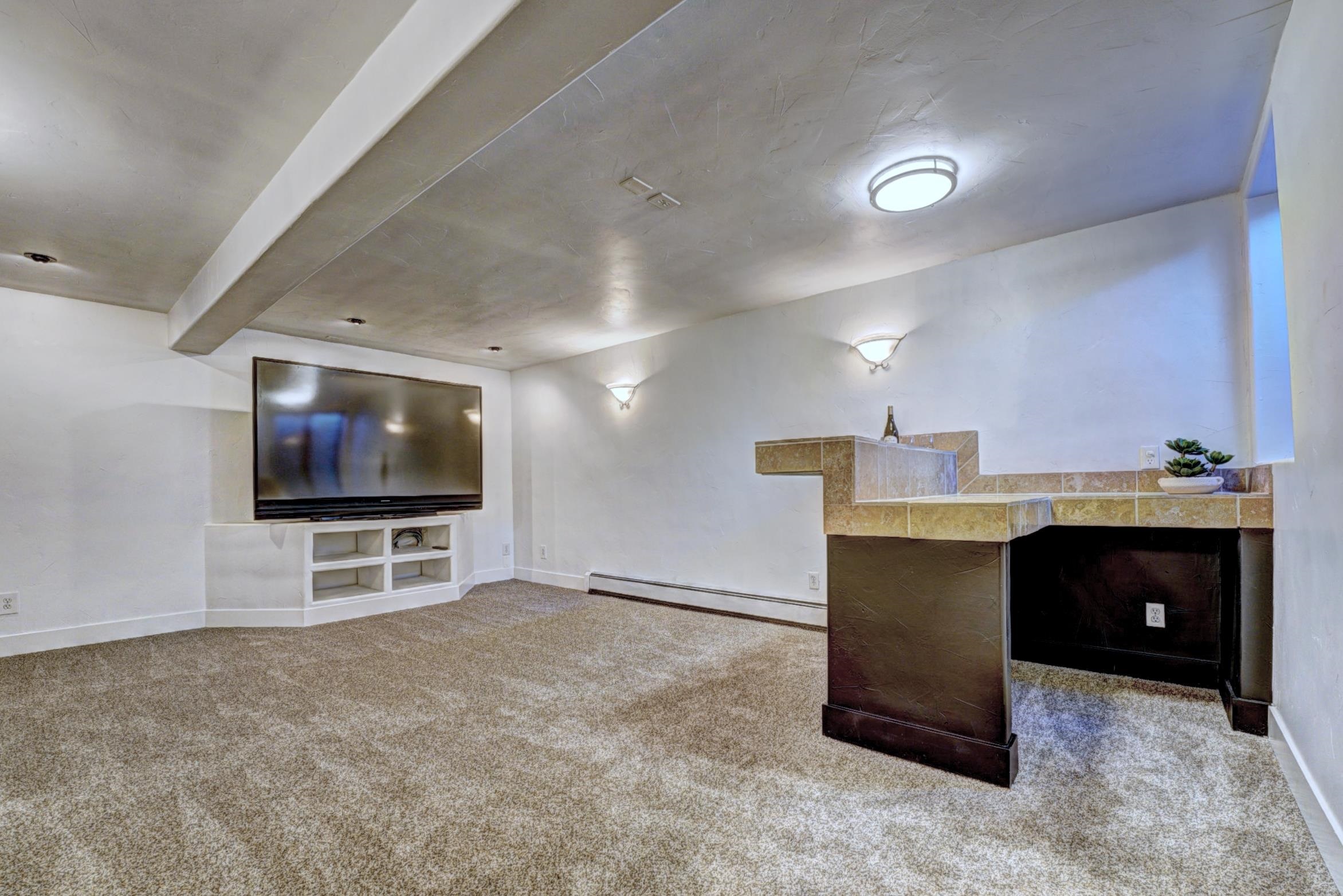 397 Ridge Cir Drive, Unit 8 Grand Junction, CO 81507 - Photo 22 of 40 a living room with furniture and a flat screen tv