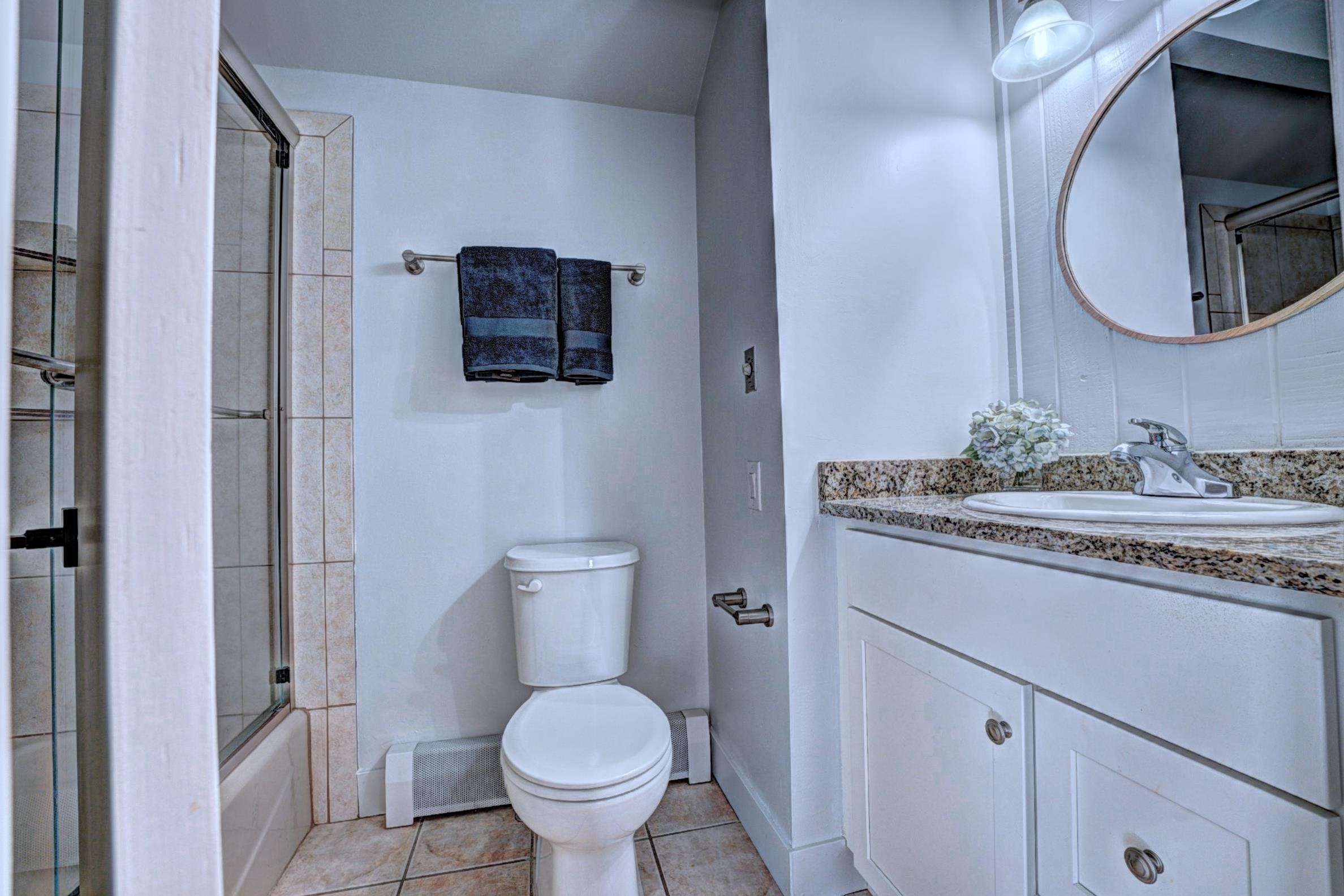 397 Ridge Cir Drive, Unit 8 Grand Junction, CO 81507 - Photo 26 of 40 a bathroom with a granite countertop toilet sink and mirror
