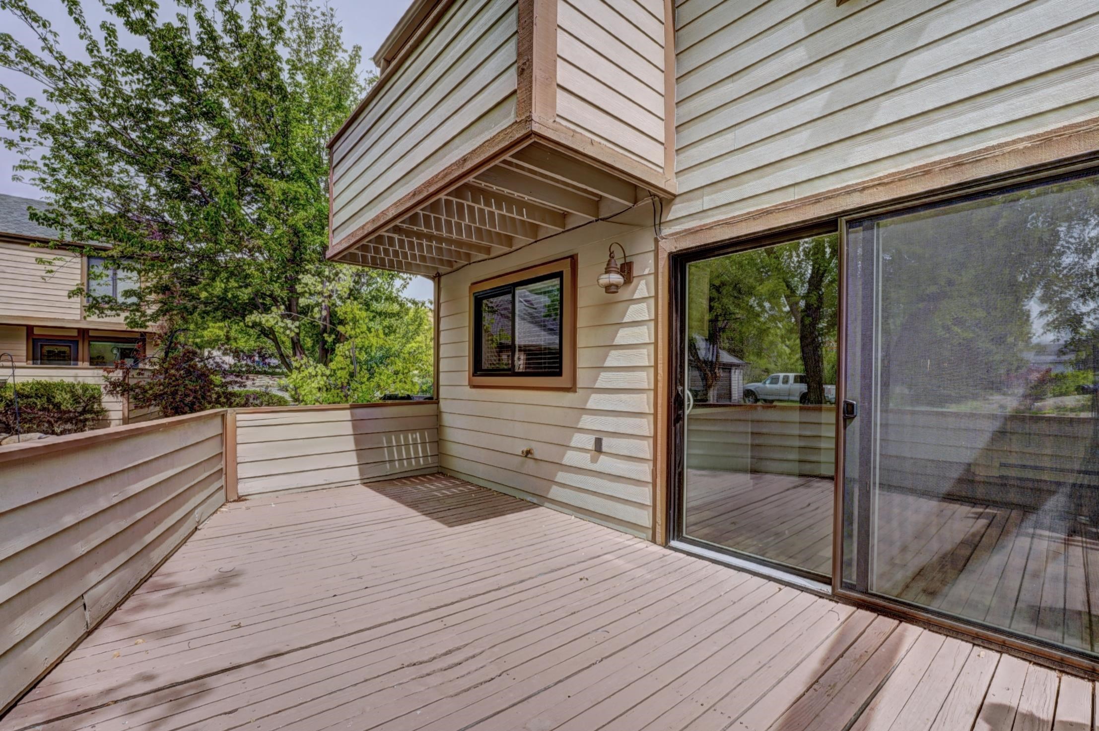 397 Ridge Cir Drive, Unit 8 Grand Junction, CO 81507 - Photo 31 of 40 a view of a balcony with wooden floor and iron stairs