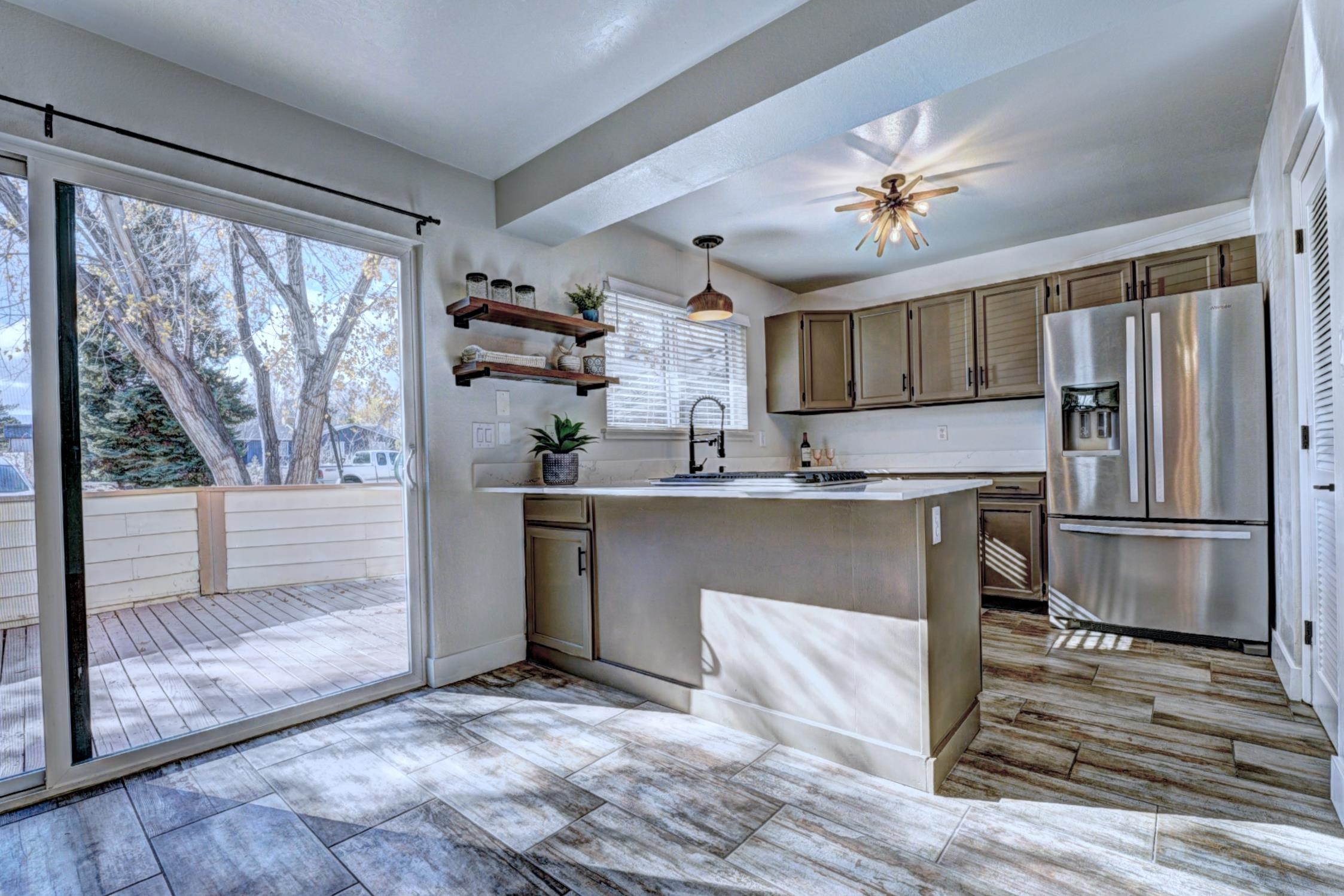 397 Ridge Cir Drive, Unit 8 Grand Junction, CO 81507 - Photo 8 of 40 a kitchen with kitchen island a counter appliances a sink and cabinets