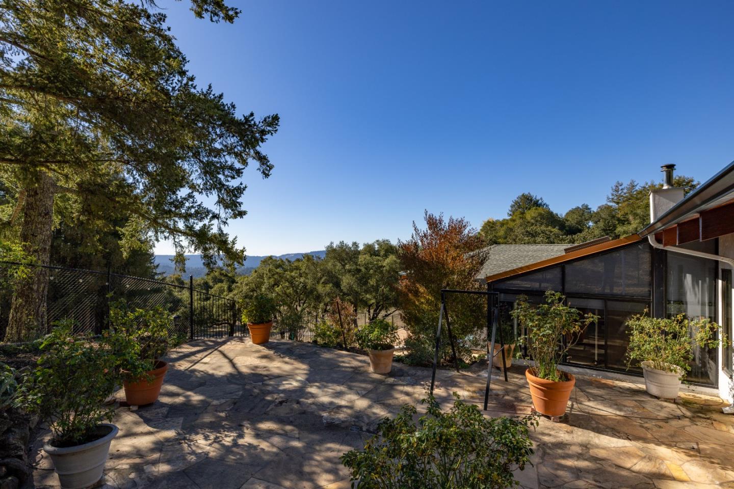 1390 Weston Ridge Road Scotts Valley, CA 95066 - Photo 46 of 55 a view of a patio with table and chairs under an umbrella