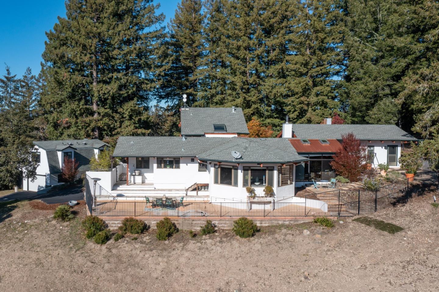 1390 Weston Ridge Road Scotts Valley, CA 95066 - Photo 48 of 55 a front view of a house with a yard table and chairs