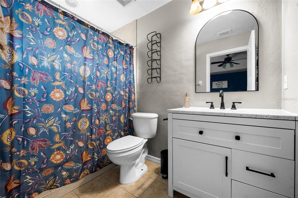 470 Margaret Street Bronson, FL 32621 - Photo 13 of 22 a bathroom with a sink mirror vanity and toilet