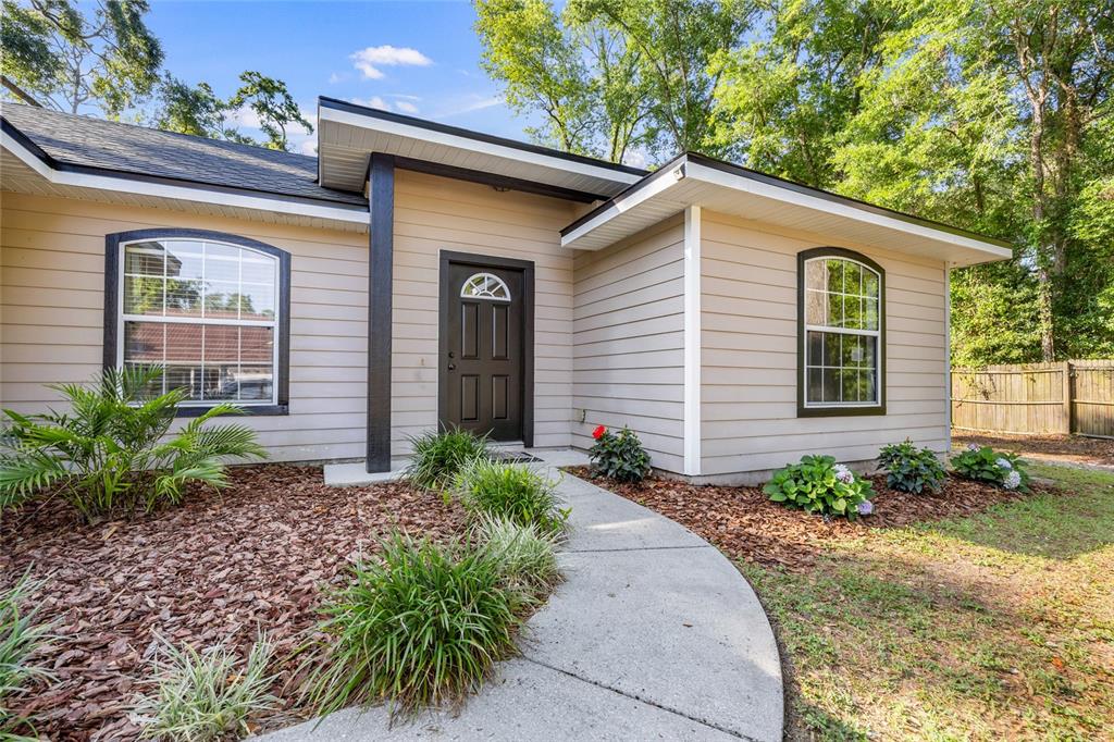 470 Margaret Street Bronson, FL 32621 - Photo 2 of 22 a front view of a house with garden