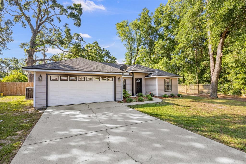 470 Margaret Street Bronson, FL 32621 - Photo 21 of 22 a front view of a house with a yard and garage