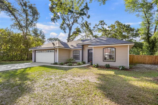 a view of a house with a yard and garage