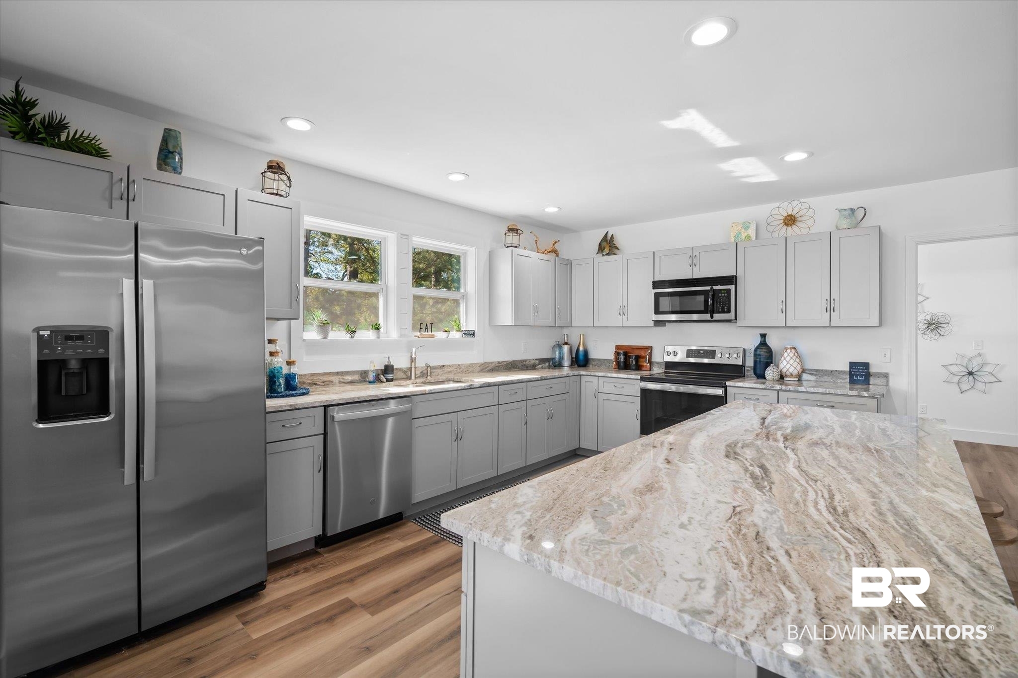 15111 Regus Road Coden, AL 36523 - Photo 7 of 35 Kitchen with appliances with stainless steel finishes, dark wood-style flooring, gray cabinetry, light stone counters, and recessed lighting