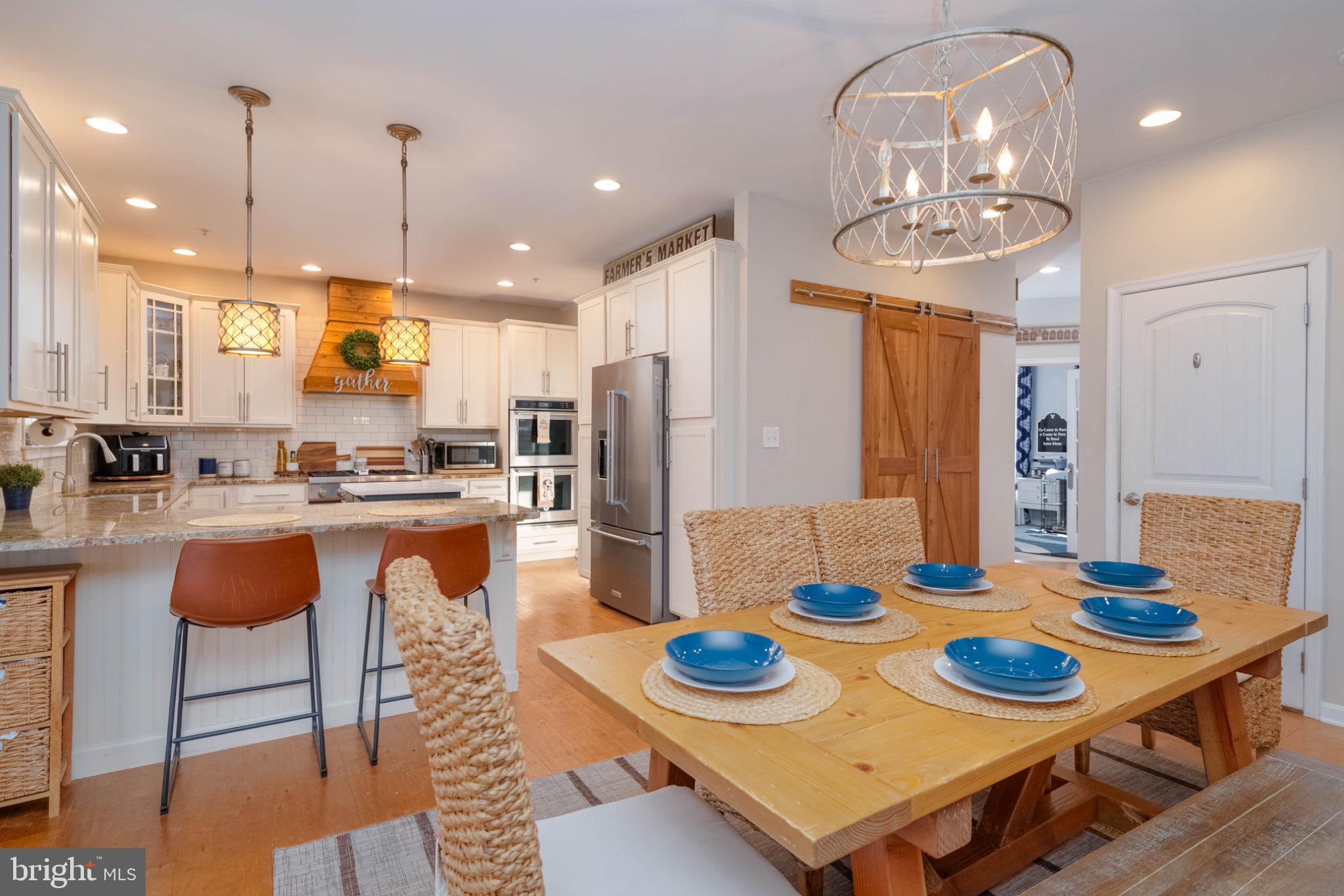 639 Old Orchard Road Bel Air, MD 21014 - Photo 10 of 46 a kitchen with stainless steel appliances kitchen island granite countertop a dining table and chairs