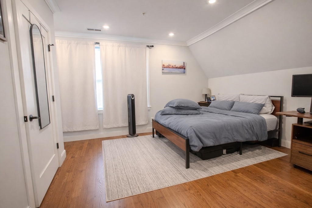 53 Quint Avenue, Unit 3 Boston, MA 02134 - Photo 11 of 18 a living room with a bed and wooden floor