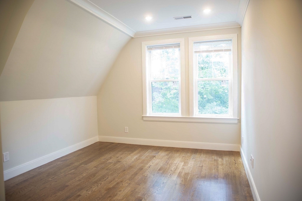 53 Quint Avenue, Unit 3 Boston, MA 02134 - Photo 16 of 18 an empty room with wooden floor and windows