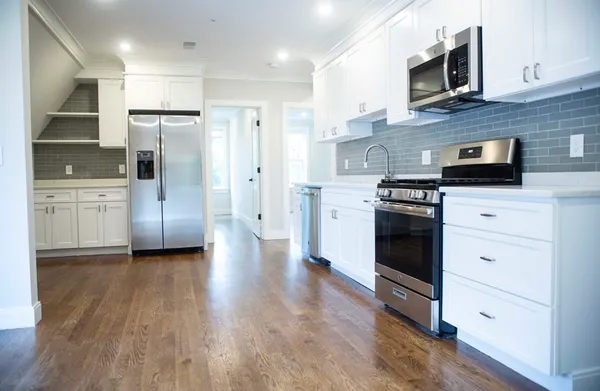 a kitchen with stainless steel appliances a stove microwave and refrigerator