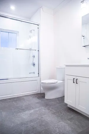 a bathroom with a toilet and a shower
