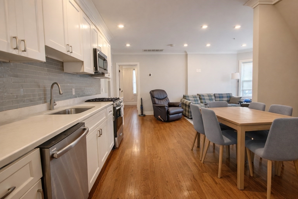 53 Quint Avenue, Unit 3 Boston, MA 02134 - Photo 3 of 18 a kitchen with sink table and chairs