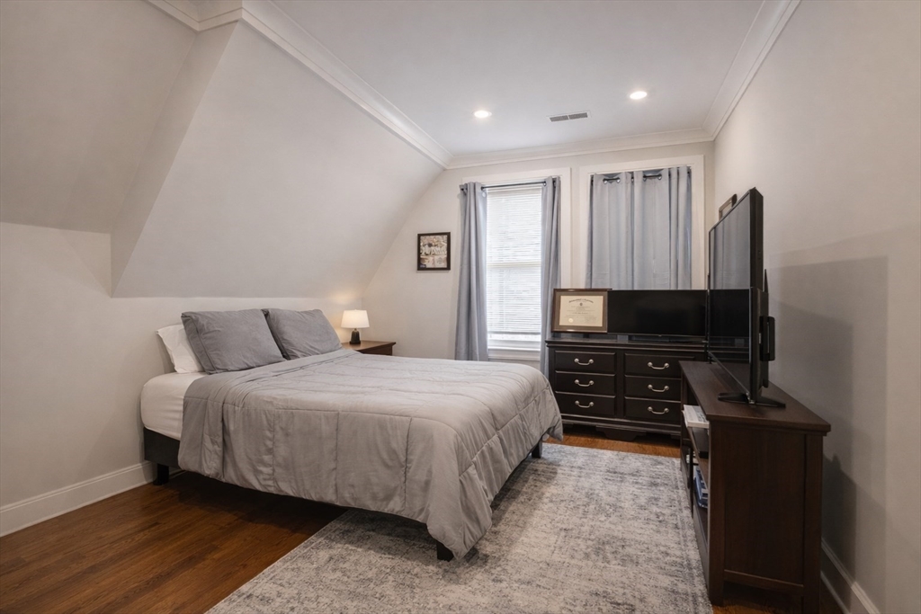 53 Quint Avenue, Unit 3 Boston, MA 02134 - Photo 5 of 18 a bedroom with a bed and a flat screen tv