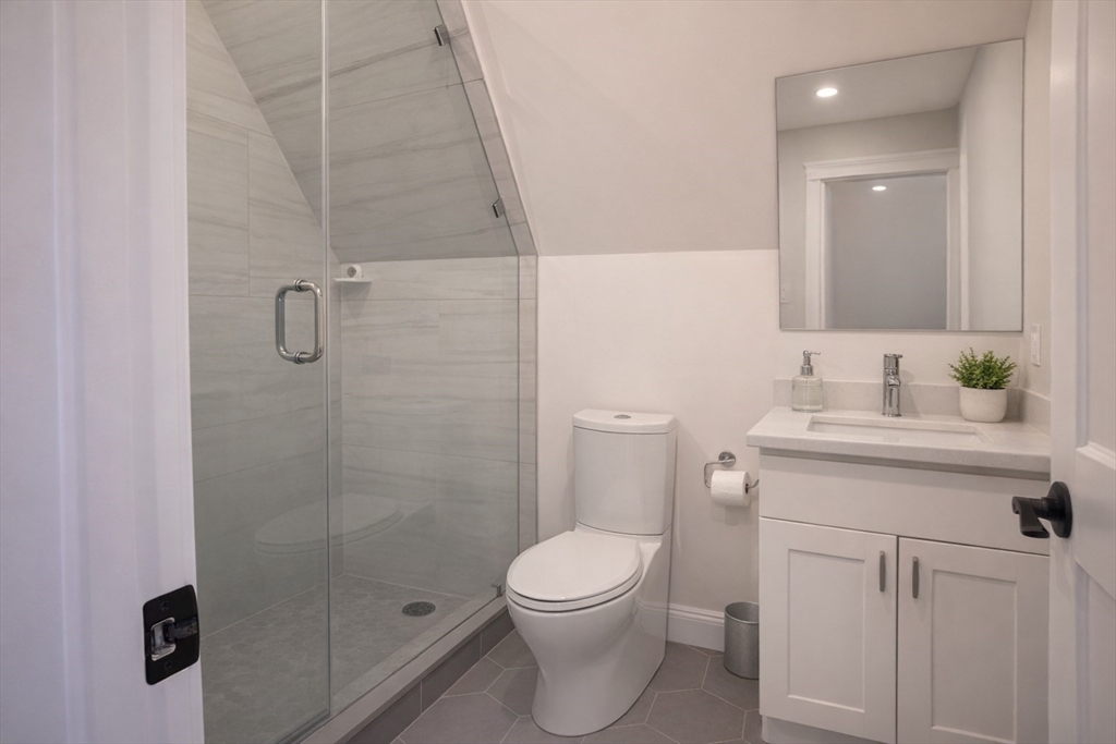 53 Quint Avenue, Unit 3 Boston, MA 02134 - Photo 7 of 18 a bathroom with a sink a toilet and shower