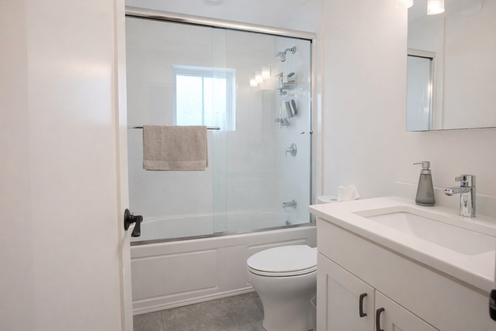 53 Quint Avenue, Unit 3 Boston, MA 02134 - Photo 8 of 18 a bathroom with a sink a toilet and shower
