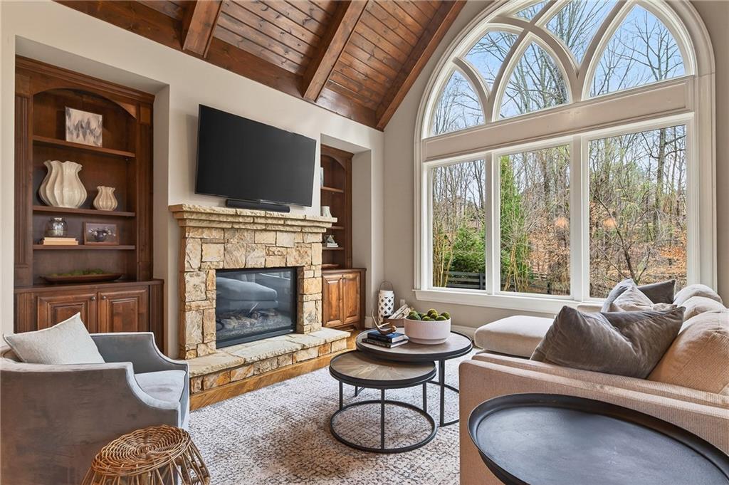 16750 Quayside Drive Milton, GA 30004 - Photo 11 of 53 a living room with furniture a flat screen tv and a fireplace
