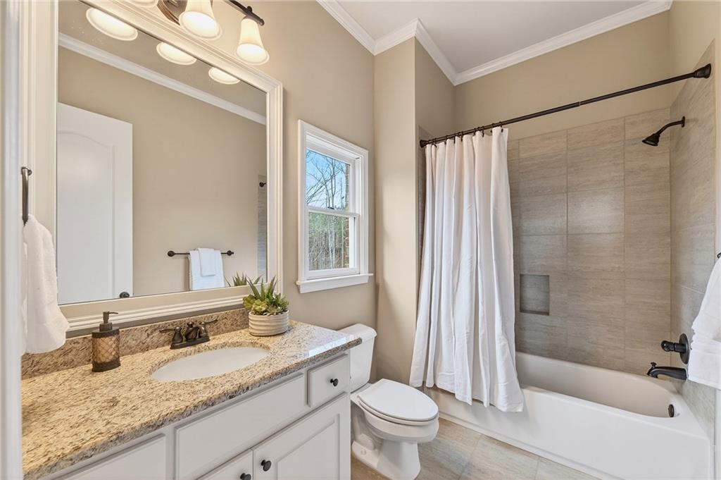 16750 Quayside Drive Milton, GA 30004 - Photo 16 of 53 a bathroom with a granite countertop sink toilet and shower