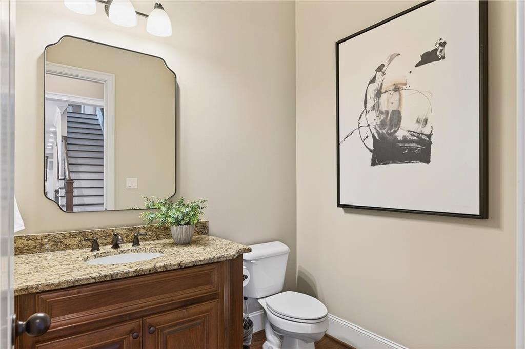 16750 Quayside Drive Milton, GA 30004 - Photo 18 of 53 a bathroom with a granite countertop sink and a mirror