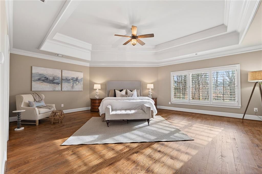 16750 Quayside Drive Milton, GA 30004 - Photo 19 of 53 a bedroom with a bed and wooden floor